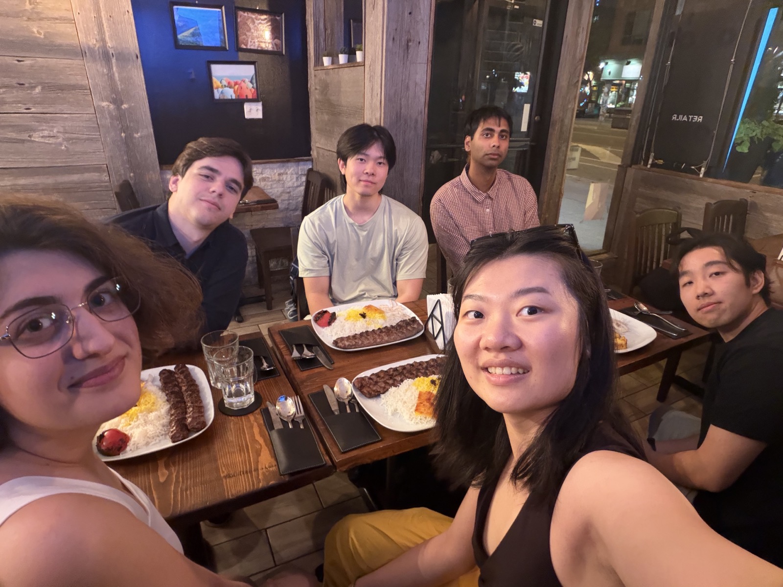 Friends gathered around a restaurant table after an Art and Social event